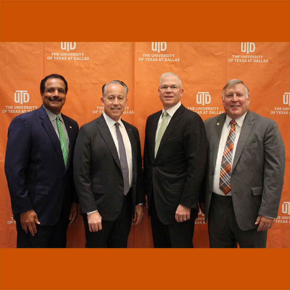 Four men standing together.