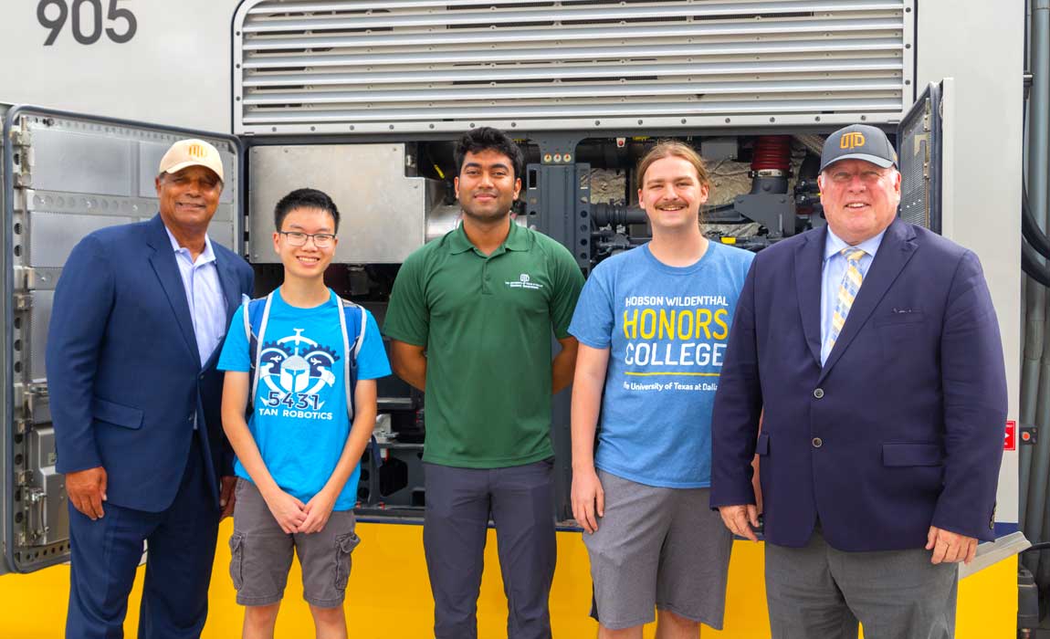 Dr. Calvin D. Jamison, vice president for Facilities & Economic Development (left), Dr. Richard C. Benson, president of The University of Texas at Dallas (right), and a few UTD students examine the train’s engine.