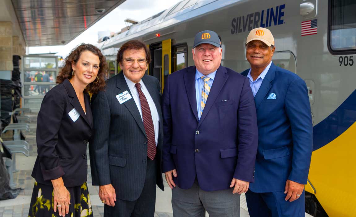 From left: Dee Leggett and Gary Slagel from the DART Board join Dr. Calvin D. Jamison, vice president for Facilities & Economic Development, and Dr. Richard C. Benson, president of The University of Texas at Dallas, on a tour of one of the new trains that will be serving UTD Station.