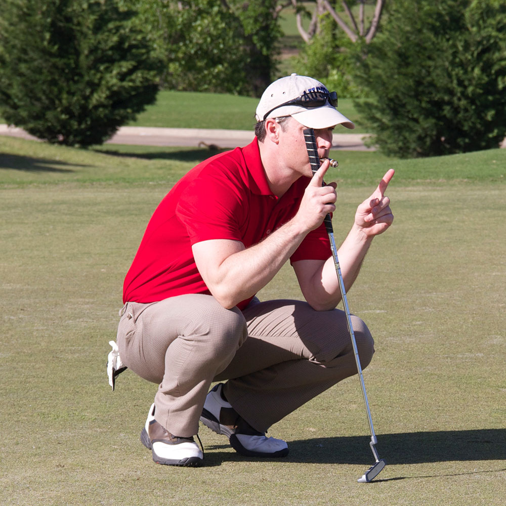 Scholarship Golf Tournament. A golfer calculating his next shot.