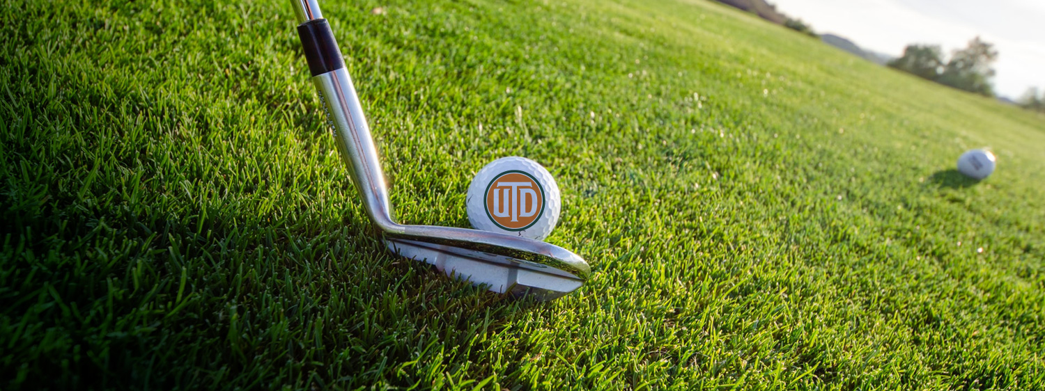 The 2026 UT Dallas Annual Scholarship Golf Tournament. Download Tournament Highlights. A golf club about to hit a ball bearing the UT Dallas logo across a golf course. The words “From Tees to Degrees” float over the scene.